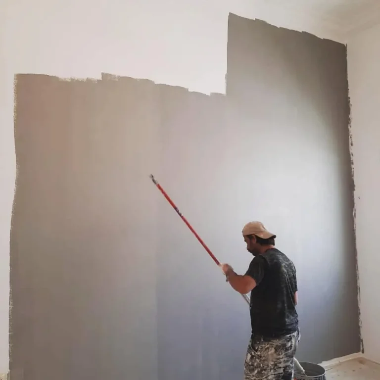 Interior wall being painted grey by a Pearl painter